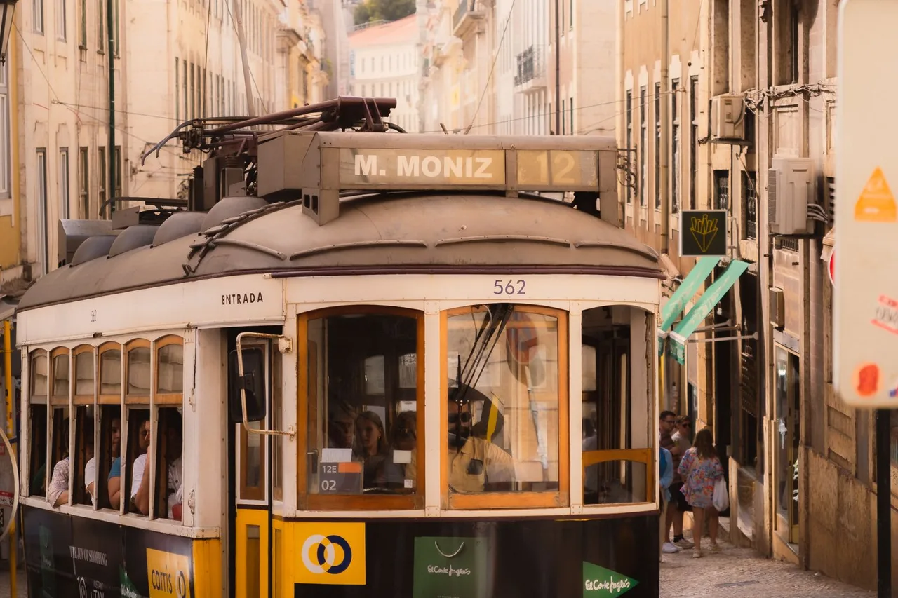 Yellow tram on a narrow Lisbon street